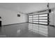 Spacious garage with a sleek epoxy floor and automatic door, perfect for vehicle storage and projects at 2642 N Fiesta St, Scottsdale, AZ 85257