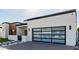 Modern home featuring a glass paneled garage door and contemporary design, with desert landscaping at 2642 N Fiesta St, Scottsdale, AZ 85257