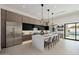 Contemporary kitchen with oversized island, modern cabinetry, and stainless steel refrigerator at 2642 N Fiesta St, Scottsdale, AZ 85257