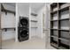 This laundry room has a stacked washer and dryer, utility shelving, and is connected to a large walk-in closet at 2642 N Fiesta St, Scottsdale, AZ 85257