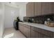 Well-equipped laundry room with modern washer/dryer, ample counter space, and custom cabinetry at 2642 N Fiesta St, Scottsdale, AZ 85257