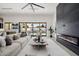 Spacious living room featuring a modern fireplace, large sofa, and open view to the outdoor pool area at 2642 N Fiesta St, Scottsdale, AZ 85257