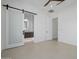 Bright main bedroom featuring a sliding barn door and ensuite bathroom at 2642 N Fiesta St, Scottsdale, AZ 85257