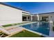 Backyard pool with lounge chairs, modern landscaping, and seamless flow to the indoor living areas at 2642 N Fiesta St, Scottsdale, AZ 85257