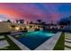 Stunning backyard pool at twilight, highlighted by decorative lighting and lush landscaping at 2642 N Fiesta St, Scottsdale, AZ 85257