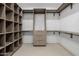 This walk-in closet features extensive shelving, custom cabinetry, and recessed lighting at 2642 N Fiesta St, Scottsdale, AZ 85257