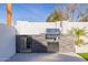 Outdoor kitchen featuring built-in grill, refrigerator, and stone accents for stylish entertaining at 2643 N Fiesta St, Scottsdale, AZ 85257