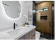 Modern bathroom with a sleek vanity, backlit mirror, and a stylish glass-enclosed shower at 2643 N Fiesta St, Scottsdale, AZ 85257