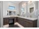 Modern bathroom featuring dual sinks, backlit mirrors, and stylish wood cabinets at 2643 N Fiesta St, Scottsdale, AZ 85257