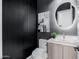 Modern powder room with textured wall, vanity with vessel sink, and backlit circular mirror at 2643 N Fiesta St, Scottsdale, AZ 85257