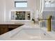 Close up of a modern bathroom featuring white countertops and gold faucet at 2643 N Fiesta St, Scottsdale, AZ 85257