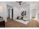 Airy bedroom with two chairs, a ceiling fan, and warm wood-look flooring at 2643 N Fiesta St, Scottsdale, AZ 85257