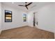 Bedroom showcasing hardwood floors, two windows, and an ensuite bathroom at 2643 N Fiesta St, Scottsdale, AZ 85257