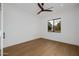 Bright bedroom featuring wood look tile flooring, a ceiling fan and a large window at 2643 N Fiesta St, Scottsdale, AZ 85257