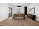 Modern dining room with sleek lighting, a large mirror, sliding glass doors, and elegant decor at 2643 N Fiesta St, Scottsdale, AZ 85257