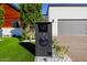 Modern home exterior featuring a unique mailbox and an address display surrounded by lush landscaping at 2643 N Fiesta St, Scottsdale, AZ 85257