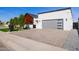 Expansive driveway leading to a modern home with a contemporary garage door and landscaped yard at 2643 N Fiesta St, Scottsdale, AZ 85257