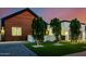 Modern home with wood accents, manicured lawn, and decorative trees in the front yard at 2643 N Fiesta St, Scottsdale, AZ 85257