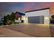 A modern home with a spacious driveway, contemporary garage door, and minimalist landscaping at 2643 N Fiesta St, Scottsdale, AZ 85257