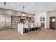 Modern kitchen with a large island, pendant lighting, stainless steel appliances, and a wine cooler at 2643 N Fiesta St, Scottsdale, AZ 85257