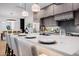 Close-up of kitchen island with pendant lights, seating, and an open layout to the dining area at 2643 N Fiesta St, Scottsdale, AZ 85257