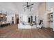 Spacious living room with fireplace, vaulted ceilings, and a modern fan with wood-look tile flooring at 2643 N Fiesta St, Scottsdale, AZ 85257