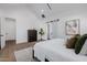 Bright main bedroom featuring walk-in closet access, light wood floors, and vaulted ceilings at 2643 N Fiesta St, Scottsdale, AZ 85257