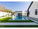 Backyard pool featuring a modern design with white accents and geometric landscaping at 2643 N Fiesta St, Scottsdale, AZ 85257