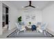 Cozy sitting area featuring four white chairs, a decorative rug, and serene wall art at 2643 N Fiesta St, Scottsdale, AZ 85257