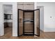 Modern wine refrigerator with glass door, wooden slats, and adjacent built-in wood cabinets at 2643 N Fiesta St, Scottsdale, AZ 85257