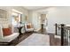 Hallway with two chairs, wood floors, and natural light from a window at 27000 N Alma School Pkwy # 2019, Scottsdale, AZ 85262