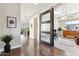 Hallway with sliding barn door leading to an office space with a view of living area at 27000 N Alma School Pkwy # 2019, Scottsdale, AZ 85262