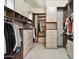 Organized walk-in closet with custom shelving and drawers providing ample storage space at 27000 N Alma School Pkwy # 2019, Scottsdale, AZ 85262