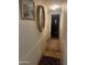 Hallway decorated with hanging wall decor, a mirror, and a decorative rug at 2744 N Trevino Pl, Mesa, AZ 85215