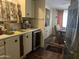 Well-lit kitchen area with stainless steel refrigerator, dining area, and ample cabinet space at 2744 N Trevino Pl, Mesa, AZ 85215