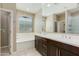 Bathroom with a double sink, a large mirror, and a separate tub at 287 N Jesse St, Chandler, AZ 85225