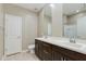 Bathroom featuring dual sinks, cabinets, and a large mirror at 287 N Jesse St, Chandler, AZ 85225