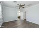 An open-concept bedroom features a connecting bathroom, and wooden-look flooring at 287 N Jesse St, Chandler, AZ 85225