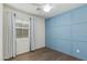 A room features hardwood flooring, a ceiling fan, and a blue panel accent wall at 287 N Jesse St, Chandler, AZ 85225