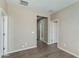 A room features hardwood flooring, beige walls and white trim, and a view into the hallway at 287 N Jesse St, Chandler, AZ 85225