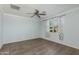 This is a bedroom with wood floors, a ceiling fan, and a window with curtains at 287 N Jesse St, Chandler, AZ 85225