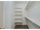 Walk-in closet with white walls, shelving, and wooden flooring at 287 N Jesse St, Chandler, AZ 85225