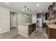 Spacious kitchen island with granite countertop, seating, pendant lighting, and stainless steel dishwasher at 287 N Jesse St, Chandler, AZ 85225