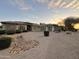 Beautiful single-story home featuring a three-car garage, desert landscaping, and decorative rock accents at 2879 E Portola Valley Ct, Gilbert, AZ 85297