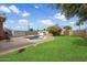 Backyard featuring a private pool surrounded by lush green grass, brick pavers, and mature trees at 2942 E Mulberry Dr, Phoenix, AZ 85016