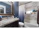 Bathroom featuring a granite vanity, framed mirror, and a tiled bathtub with shower at 2942 E Mulberry Dr, Phoenix, AZ 85016