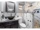 Modern bathroom with stylish marble tiling and black fixtures, including a vessel sink and rainfall shower head at 2942 E Mulberry Dr, Phoenix, AZ 85016