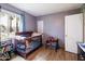 Bedroom featuring wood floors, a window, and a crib for little ones at 2942 E Mulberry Dr, Phoenix, AZ 85016