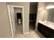 Bathroom featuring a sink with dark cabinets and a door leading to a closet and the toilet at 29573 W Mitchell Ave, Buckeye, AZ 85396