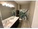 Bright bathroom featuring a modern vanity, lighted mirror, and whimsical octopus shower curtain at 29573 W Mitchell Ave, Buckeye, AZ 85396